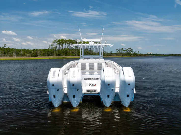  Yacht Photos Pics 2024 Invincible 37 Catamaran with quad 400 V10 engines on a serene waterway.