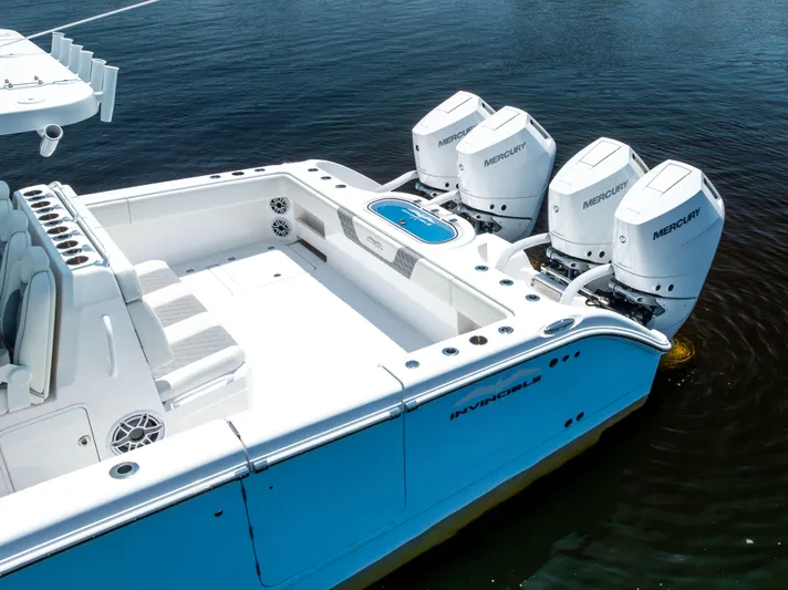  Yacht Photos Pics 2024 Invincible 37 Catamaran with four Mercury outboard engines on calm water.
