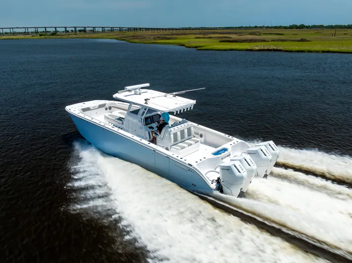  Yacht Photos Pics 2024 Invincible 37 Catamaran cruising on open water, showcasing sleek design and powerful engines.