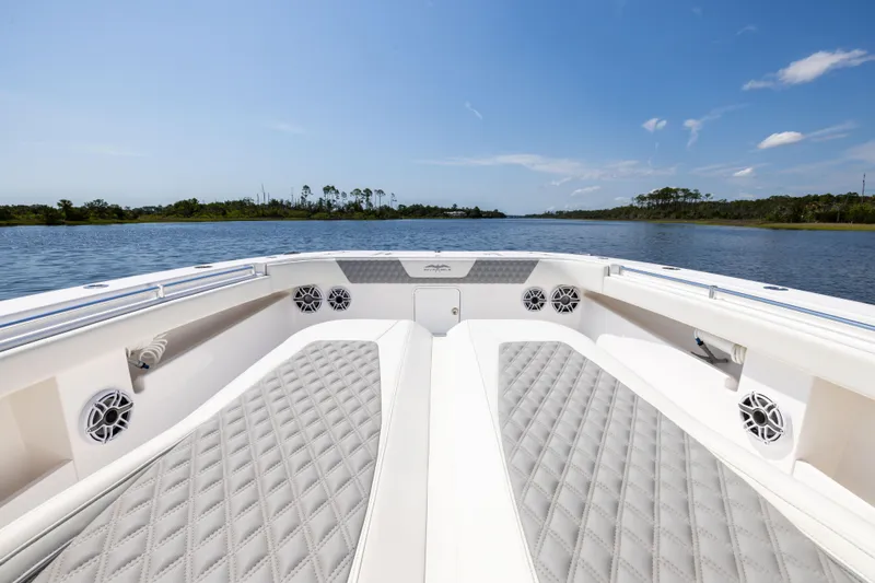  Yacht Photos Pics 2024 Invincible 37 Catamaran with luxurious seating on a serene waterway.