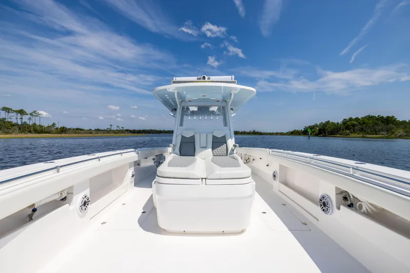  Yacht Photos Pics 2024 Invincible 37 Catamaran on calm water, showcasing sleek design and spacious deck.