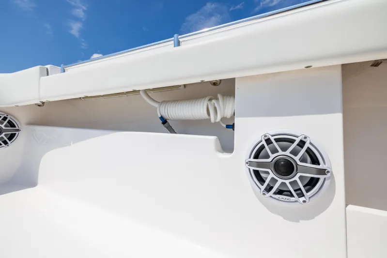  Yacht Photos Pics 2024 Invincible 37 Catamaran speaker and coiled hose detail against blue sky.