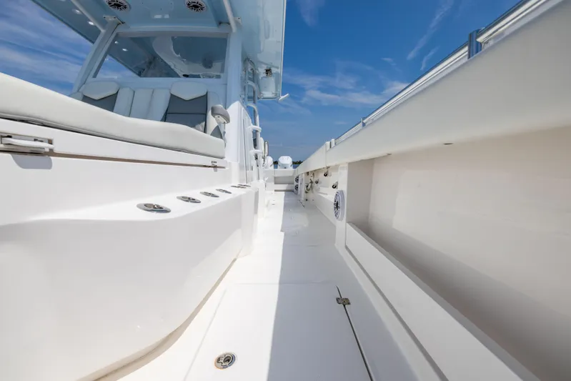 Yacht Photos Pics 2024 Invincible 37 Catamaran deck with sleek seating and modern design under a clear blue sky.