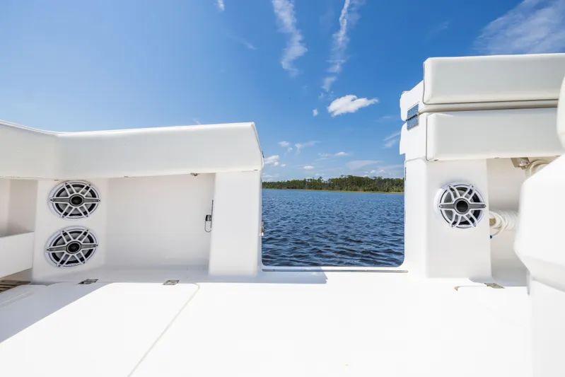  Yacht Photos Pics 2024 Invincible 37 Catamaran deck view with speakers, overlooking serene water and blue sky.