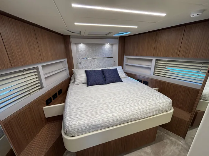  Yacht Photos Pics Luxurious cabin interior of 2025 Filippetti S55 yacht with modern wood paneling and cozy bedding.