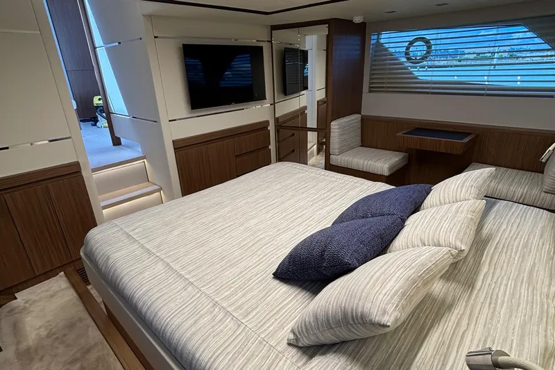  Yacht Photos Pics Luxurious 2025 Filippetti S55 yacht bedroom with modern decor and large bed.