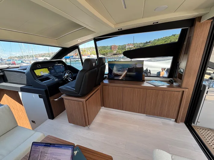  Yacht Photos Pics Luxurious interior of 2025 Filippetti S55 yacht with modern helm and scenic marina view.