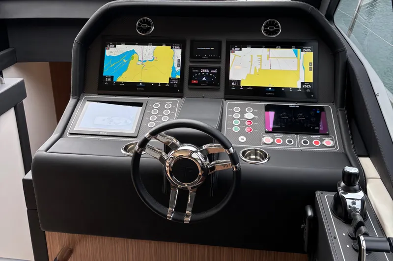  Yacht Photos Pics Control panel of 2025 Filippetti S55 yacht with navigation screens and steering wheel.