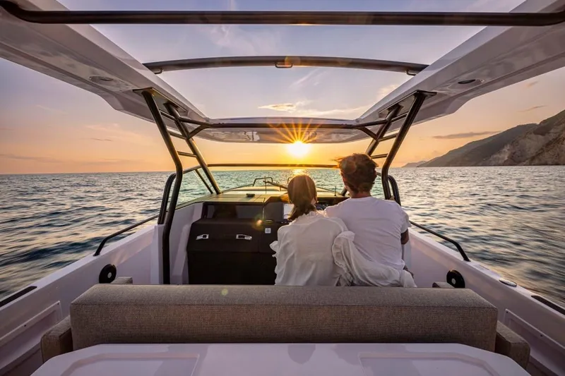  Yacht Photos Pics Couple enjoying sunset on 2025 Axopar 37 Sun Top BRABUS Trim boat.