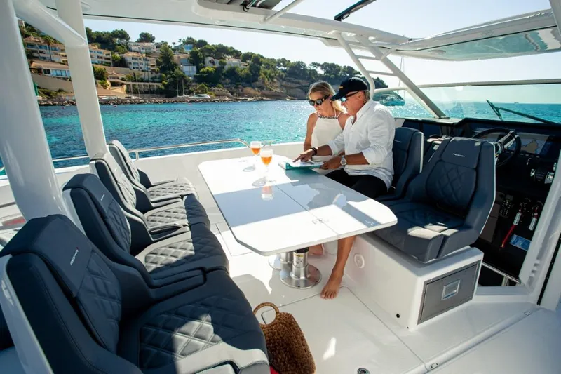  Yacht Photos Pics Couple relaxing on 2025 Axopar 37 Sun Top BRABUS Trim yacht, enjoying ocean view.