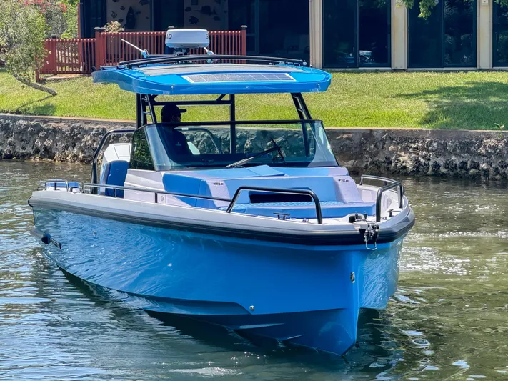  Yacht Photos Pics 2025 Axopar 37 Sun Top BRABUS Trim boat on a calm waterway.