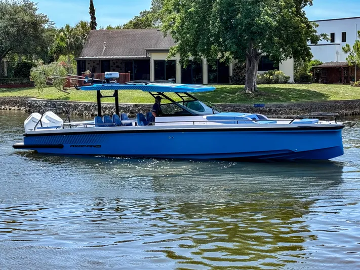  Yacht Photos Pics 2025 Axopar 37 Sun Top BRABUS Trim boat cruising on a serene waterway.