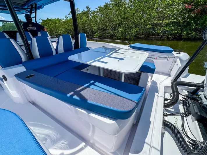  Yacht Photos Pics 2025 Axopar 37 Sun Top BRABUS Trim with blue seating and table on deck.