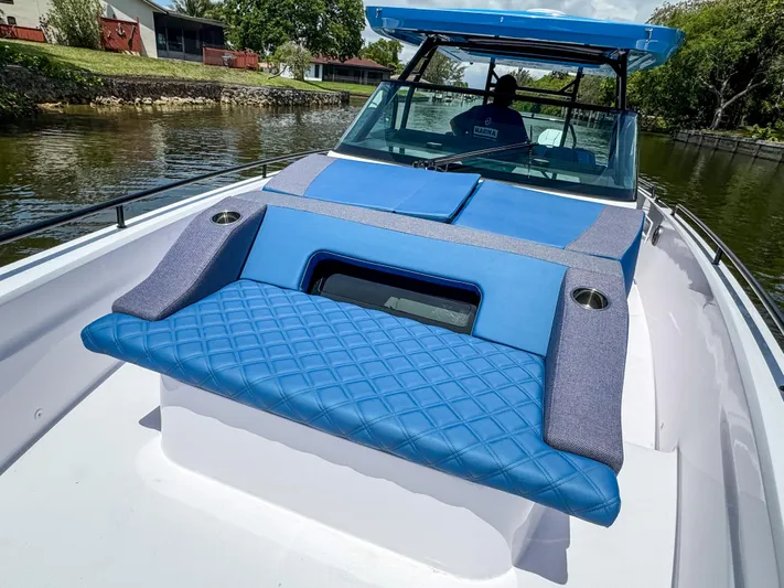  Yacht Photos Pics 2025 Axopar 37 Sun Top BRABUS Trim with blue seating on a calm waterway.