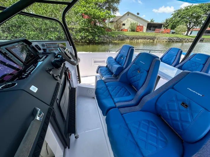  Yacht Photos Pics 2025 Axopar 37 Sun Top BRABUS Trim interior with blue seating and modern dashboard.