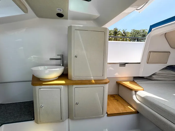  Yacht Photos Pics Luxurious interior of 2025 Axopar 37 Sun Top BRABUS Trim with modern sink and cabinetry.