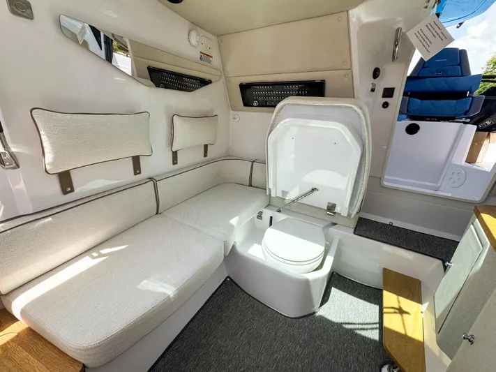  Yacht Photos Pics 2025 Axopar 37 Sun Top BRABUS Trim interior with seating and compact toilet.