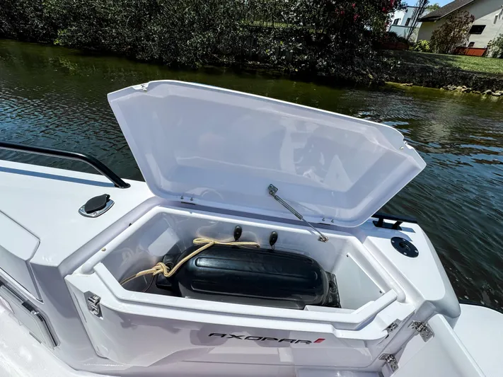  Yacht Photos Pics 2025 Axopar 37 Sun Top BRABUS Trim storage compartment open by the water.