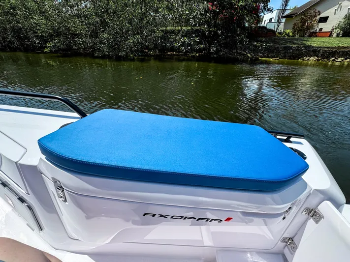  Yacht Photos Pics 2025 Axopar 37 Sun Top BRABUS Trim boat with blue seating by a river.