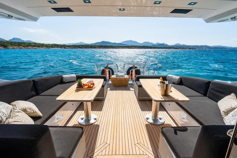 MilÙ II Yacht Photos Pics Luxurious 2009 Overmarine Mangusta 80 yacht deck with elegant seating and ocean view.