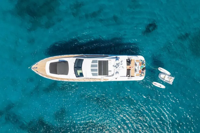 MilÙ II Yacht Photos Pics Aerial view of 2009 Overmarine Mangusta 80 yacht on clear blue water.