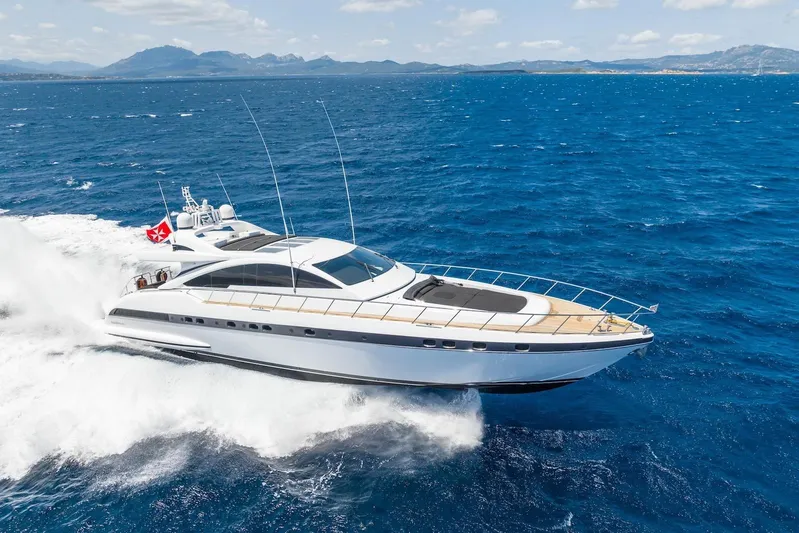 MilÙ II Yacht Photos Pics Luxurious 2009 Overmarine Mangusta 80 yacht cruising on open sea with scenic mountain backdrop.