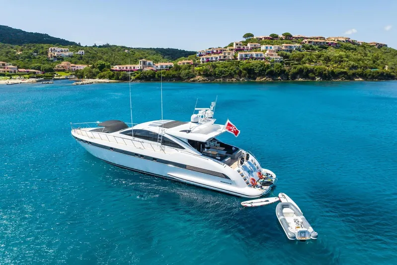 MilÙ II Yacht Photos Pics Luxurious 2009 Overmarine Mangusta 80 yacht anchored in scenic coastal waters.