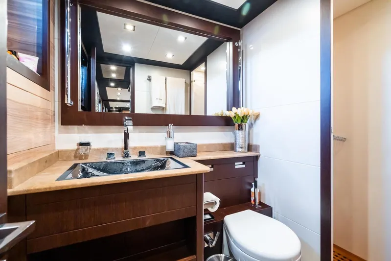 MilÙ II Yacht Photos Pics Luxurious bathroom on 2009 Overmarine Mangusta 80 yacht, featuring elegant wood finishes and modern fixtures.