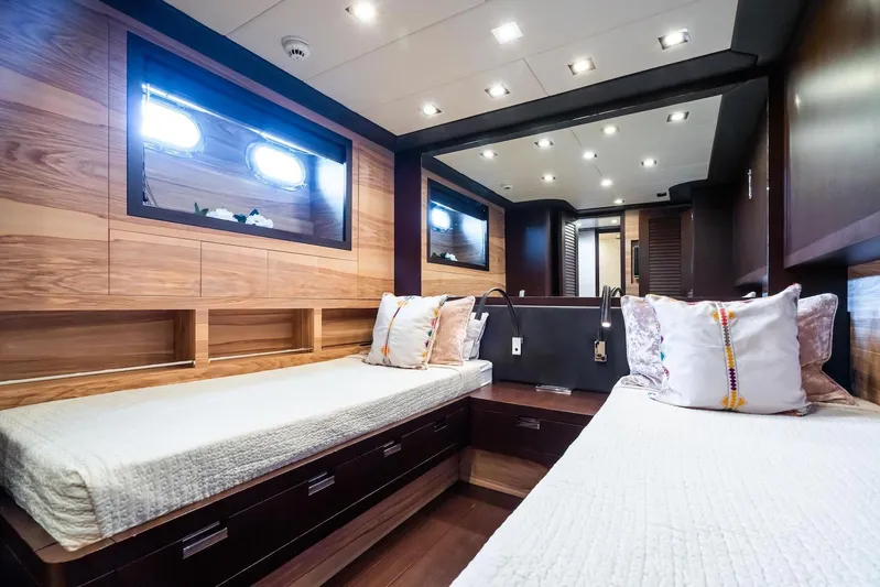 MilÙ II Yacht Photos Pics Luxurious 2009 Overmarine Mangusta 80 yacht cabin with twin beds and elegant wood paneling.