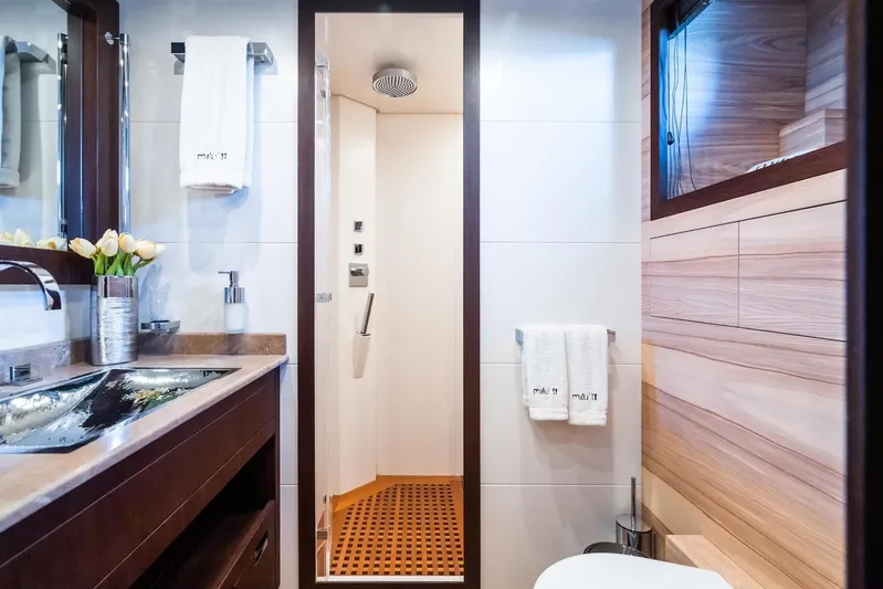 MilÙ II Yacht Photos Pics Luxurious bathroom on 2009 Overmarine Mangusta 80 yacht, featuring modern fixtures and elegant wood accents.