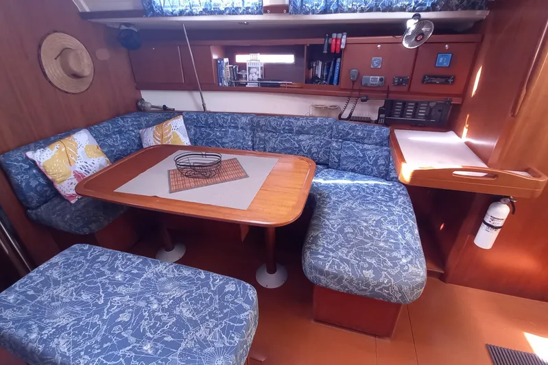 We Reach Yacht Photos Pics Interior of 2011 Dufour 425 Grand Large yacht with cozy seating and wooden table.