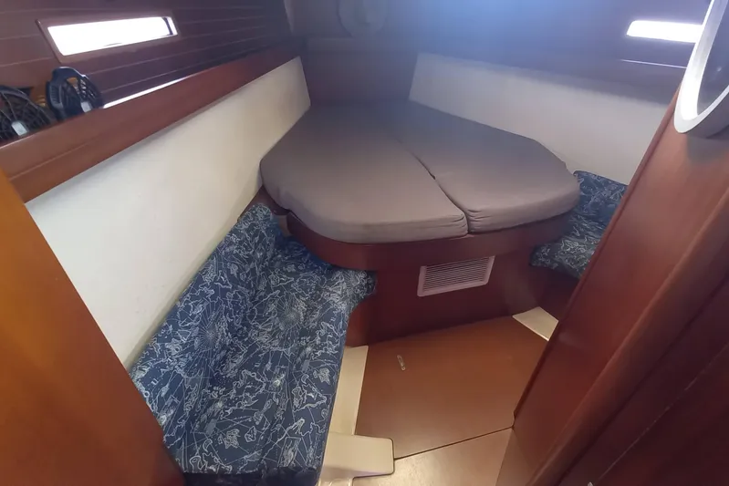 We Reach Yacht Photos Pics Cozy cabin interior of 2011 Dufour 425 Grand Large sailboat with cushioned seating.