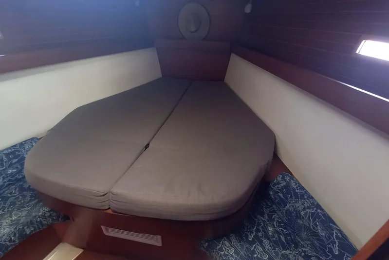 We Reach Yacht Photos Pics Cozy cabin interior of 2011 Dufour 425 Grand Large sailboat with cushioned bed.