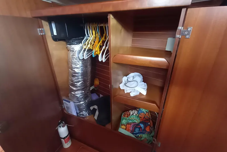 We Reach Yacht Photos Pics Wooden closet interior on 2011 Dufour 425 Grand Large yacht with hangers and storage.