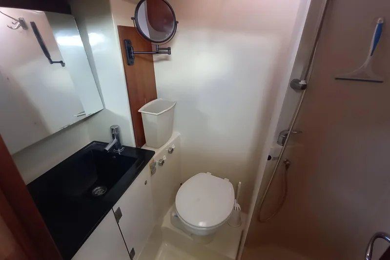 We Reach Yacht Photos Pics Bathroom interior of 2011 Dufour 425 Grand Large yacht, featuring sink and toilet.