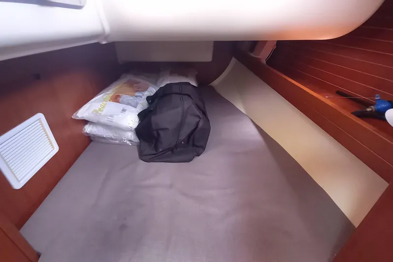 We Reach Yacht Photos Pics Cabin interior of 2011 Dufour 425 Grand Large yacht with bedding and bag.