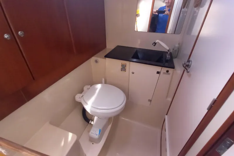 We Reach Yacht Photos Pics Bathroom interior of 2011 Dufour 425 Grand Large yacht, featuring toilet and sink.