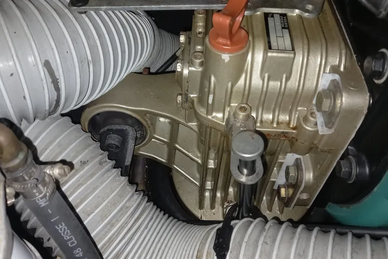 We Reach Yacht Photos Pics Engine compartment of 2011 Dufour 425 Grand Large sailboat, featuring mechanical components and hoses.