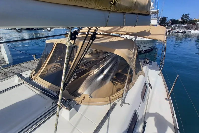 We Reach Yacht Photos Pics 2011 Dufour 425 Grand Large sailboat docked at marina, featuring tan canopy.