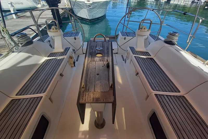 We Reach Yacht Photos Pics Cockpit of 2011 Dufour 425 Grand Large sailboat with wooden seating and steering wheels.
