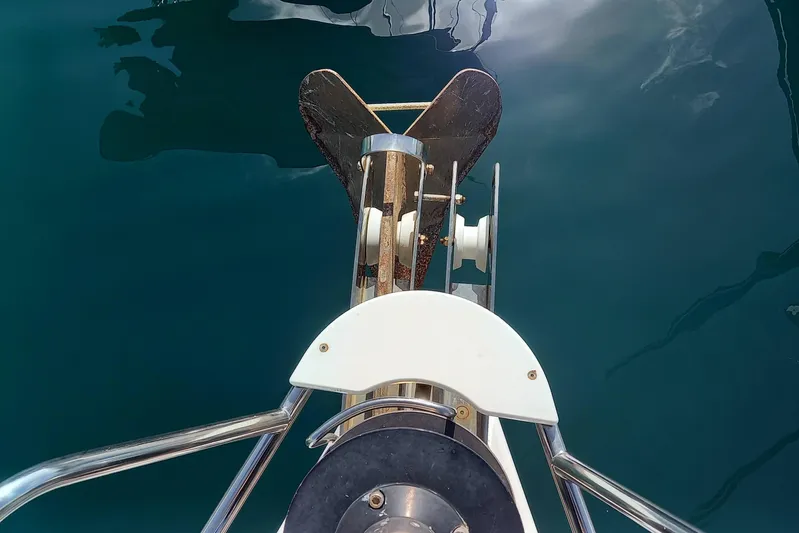 We Reach Yacht Photos Pics Bow view of 2011 Dufour 425 Grand Large yacht with anchor over calm water.