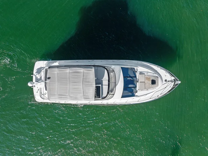 Guilty Pleasure Yacht Photos Pics Aerial view of 2014 Sea Ray 510 Fly yacht on green water.