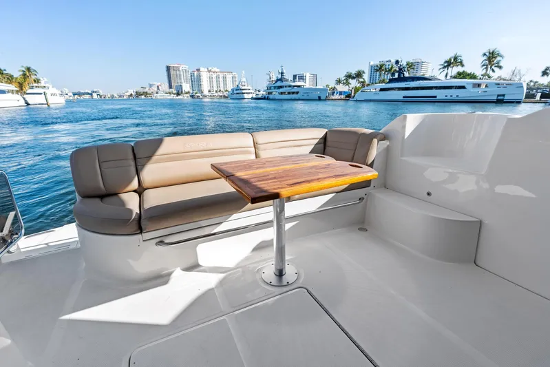 Guilty Pleasure Yacht Photos Pics Luxurious 2014 Sea Ray 510 Fly yacht with elegant seating and scenic waterfront view.