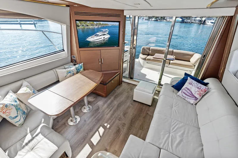 Guilty Pleasure Yacht Photos Pics Luxurious interior of 2014 Sea Ray 510 Fly yacht with elegant seating and scenic water views.