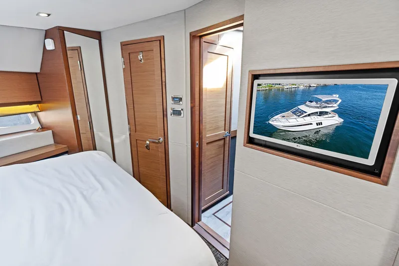 Guilty Pleasure Yacht Photos Pics Interior of 2014 Sea Ray 510 Fly yacht cabin with modern decor and wall-mounted screen.