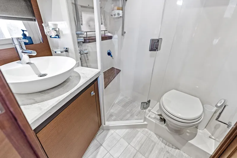 Guilty Pleasure Yacht Photos Pics Luxurious bathroom in 2014 Sea Ray 510 Fly yacht with modern fixtures and glass shower.