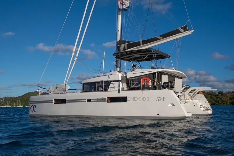 Oui Cherie Yacht Photos Pics 2017 Lagoon 52 F catamaran sailing on blue waters under a clear sky.