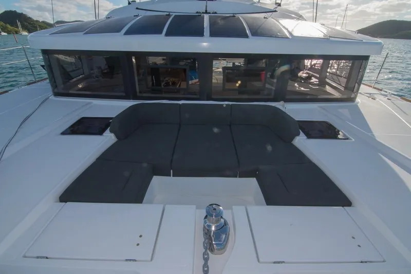 Oui Cherie Yacht Photos Pics 2017 Lagoon 52 F yacht deck with seating, surrounded by serene waters.