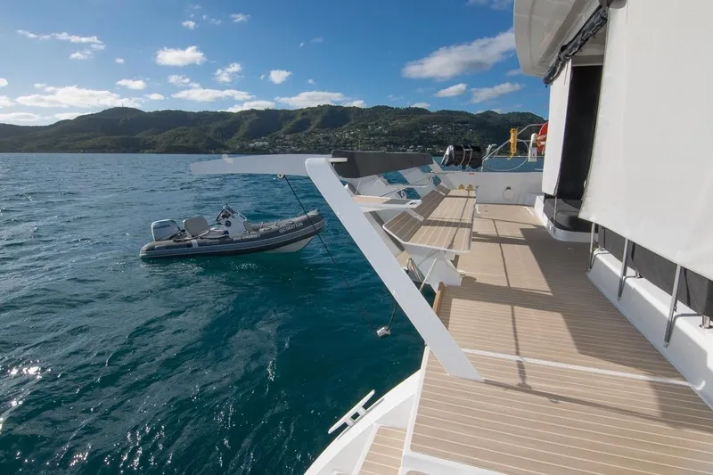 Oui Cherie Yacht Photos Pics 2017 Lagoon 52 F yacht deck with scenic ocean and mountain backdrop.