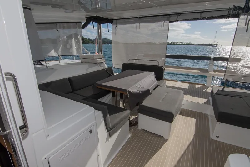 Oui Cherie Yacht Photos Pics Luxurious 2017 Lagoon 52 F yacht deck with seating, table, and ocean view.